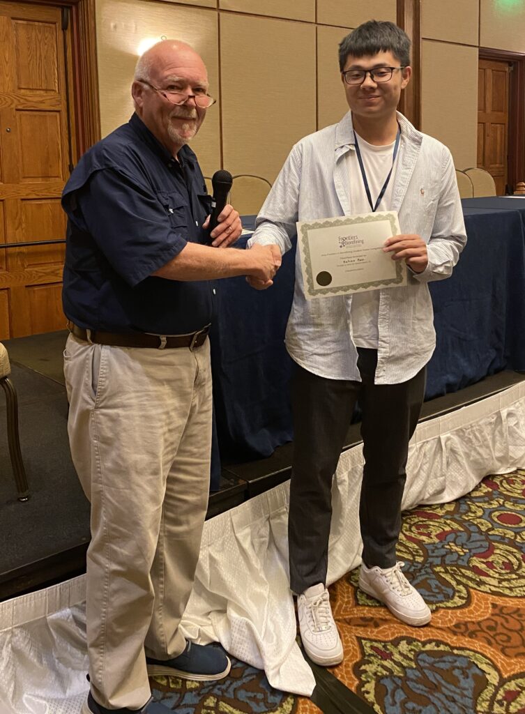 Third place student poster competition winner Kehao Ren receiving award from Tim Rials.